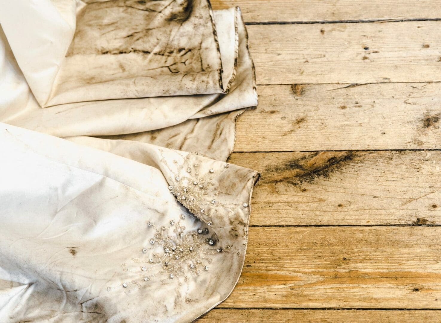 A white sheet on a wooden floor.