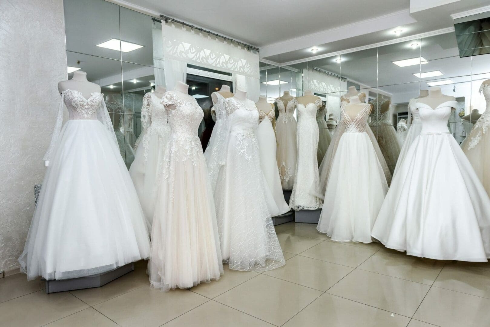 Wedding dresses on display in a bridal shop.