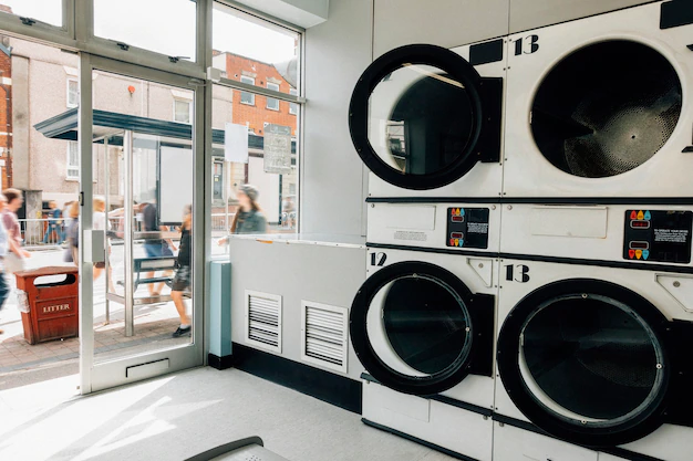 A laundry room with a lot of washing machines.